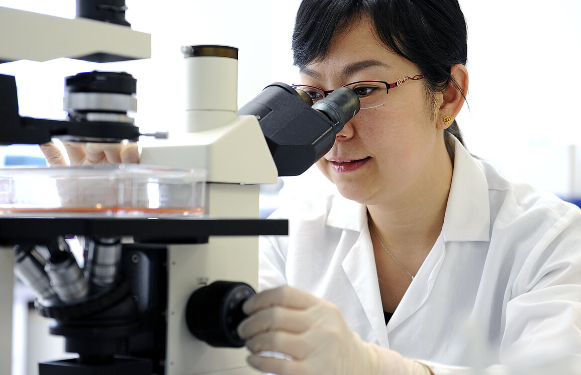 Image of student with microscope Image of student with microscope