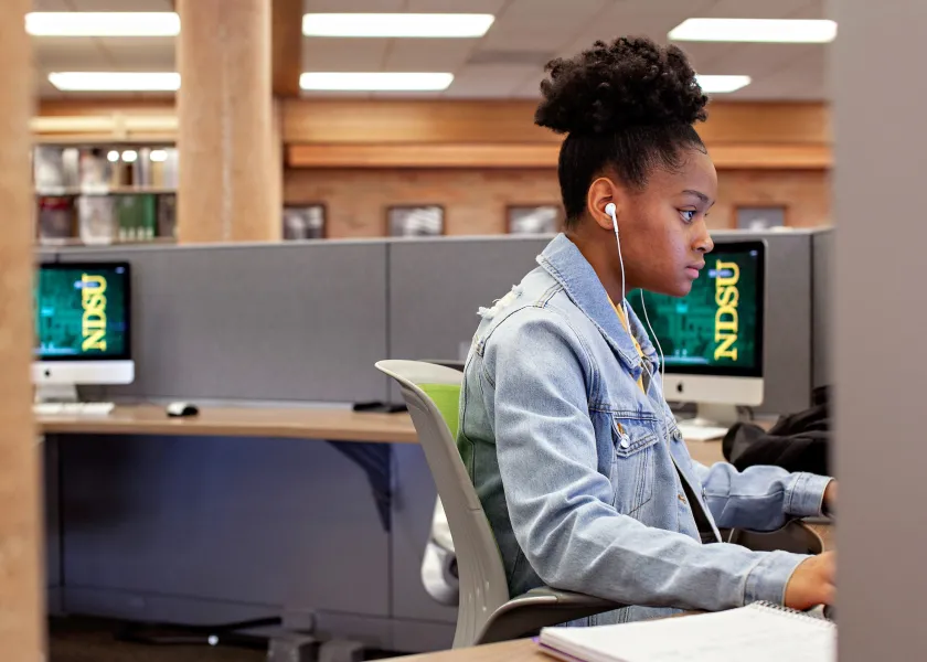 student working in an office cubicle